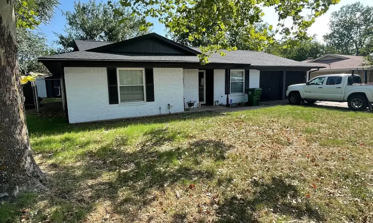 Professional roofing crew working on a residential roof in Athens